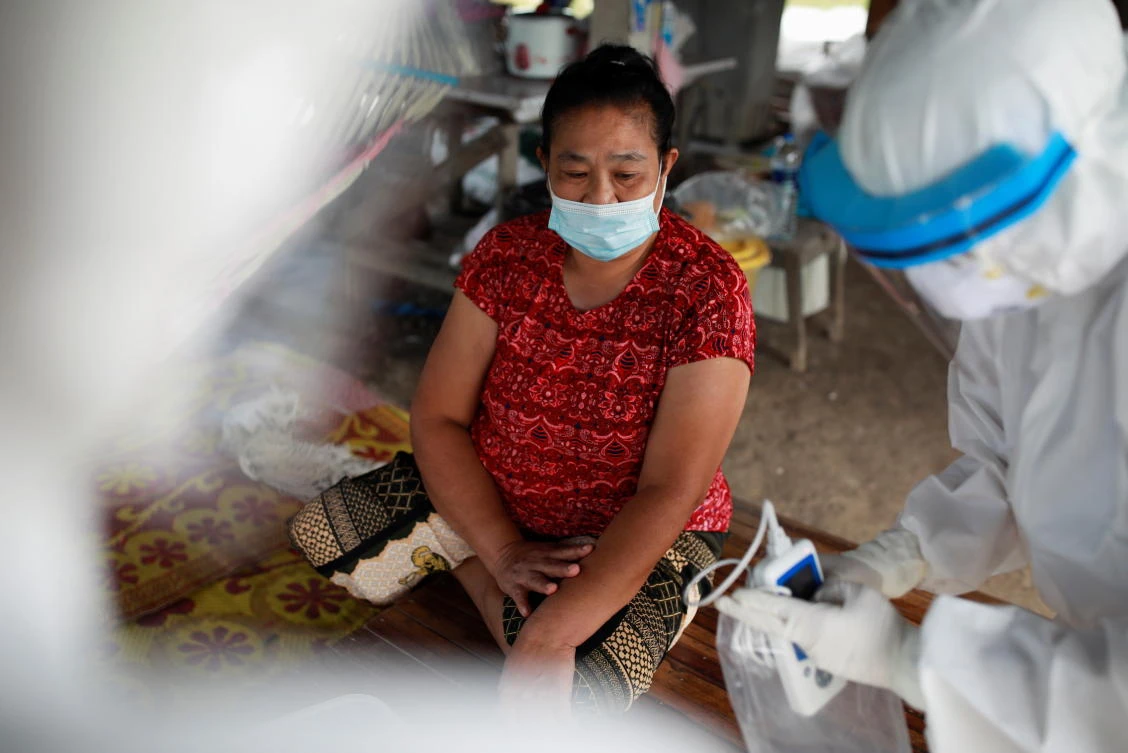 Public health officers prepare to administer a coronavirus disease (COVID-19) swab test near Bangkok. A global surge in cases has rattled oil markets. (Reuters)