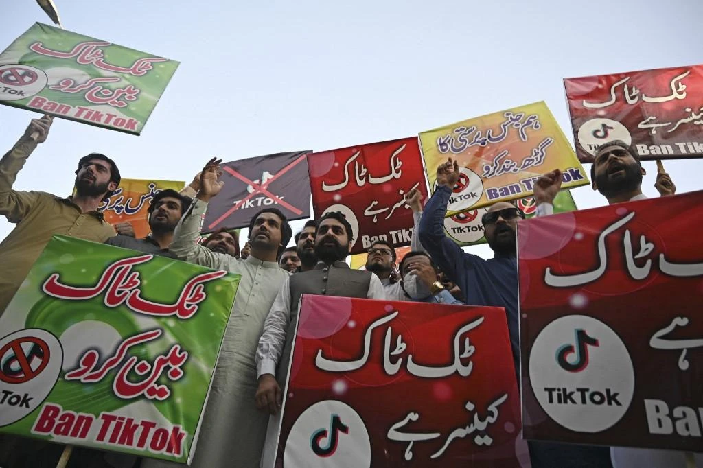 Pakistani activists carry banners and placards as they take part in a demonstration demanding the ban of a social media application TikTok in Islamabad on June 26, 2021. (AFP)