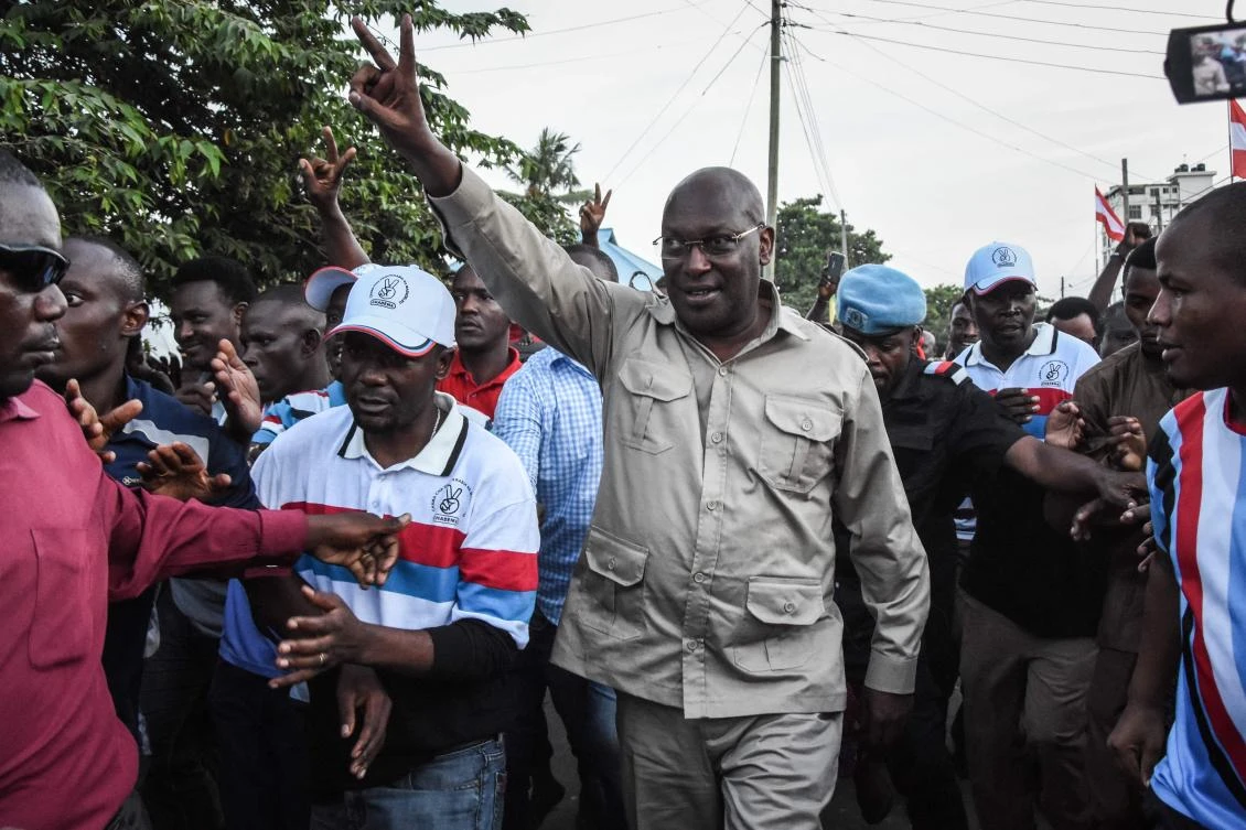 In this file photograph taken on March 14, 2020, Tanzania's Chadema Party chairman Freeman Mbowe gestures as he arrives at the party's headquarters after being released from Segerea Prison in Dar es Salaam. (AFP)