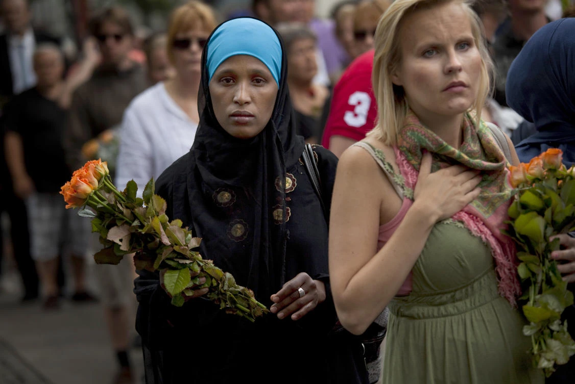 In this Sunday, July 24, 2011 file photo, women carry flowers as they arrive for a memorial service at Oslo Cathedral in the aftermath of the bombing and shooting attacks on Norway's government headquarters and a youth retreat, in Oslo. (File/AP)