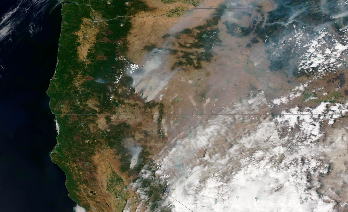 This satellite image shows an overview of wildfires from western US on July 18, 2021. Extremely dry conditions and heat waves tied to climate change have made wildfires harder to fight.(Maxar Technologies via AP)