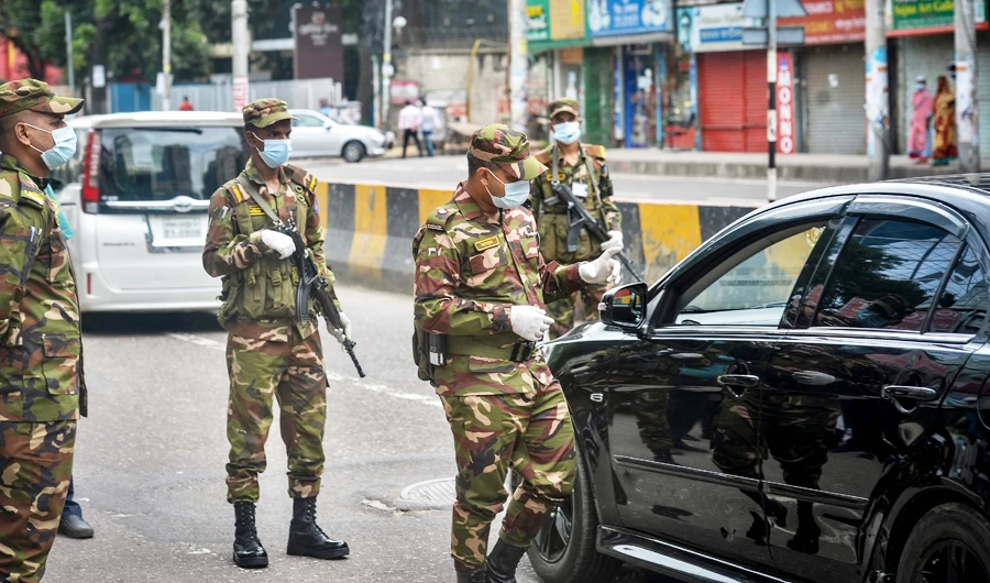 Security personnel positioned on the road to enforce a lockdown imposed by the Bangladesh's government to curb the spread of Covid-19 coronavirus in Dhaka on July 23, 2021. (AFP)
