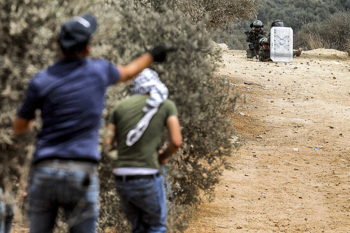 Palestinian protesters confront Israeli forces in the town of Beita, near the occupied West Bank city of Nablus, on July 23, 2021, after a protest against the Israeli outpost of Eviatar. (File/AFP)