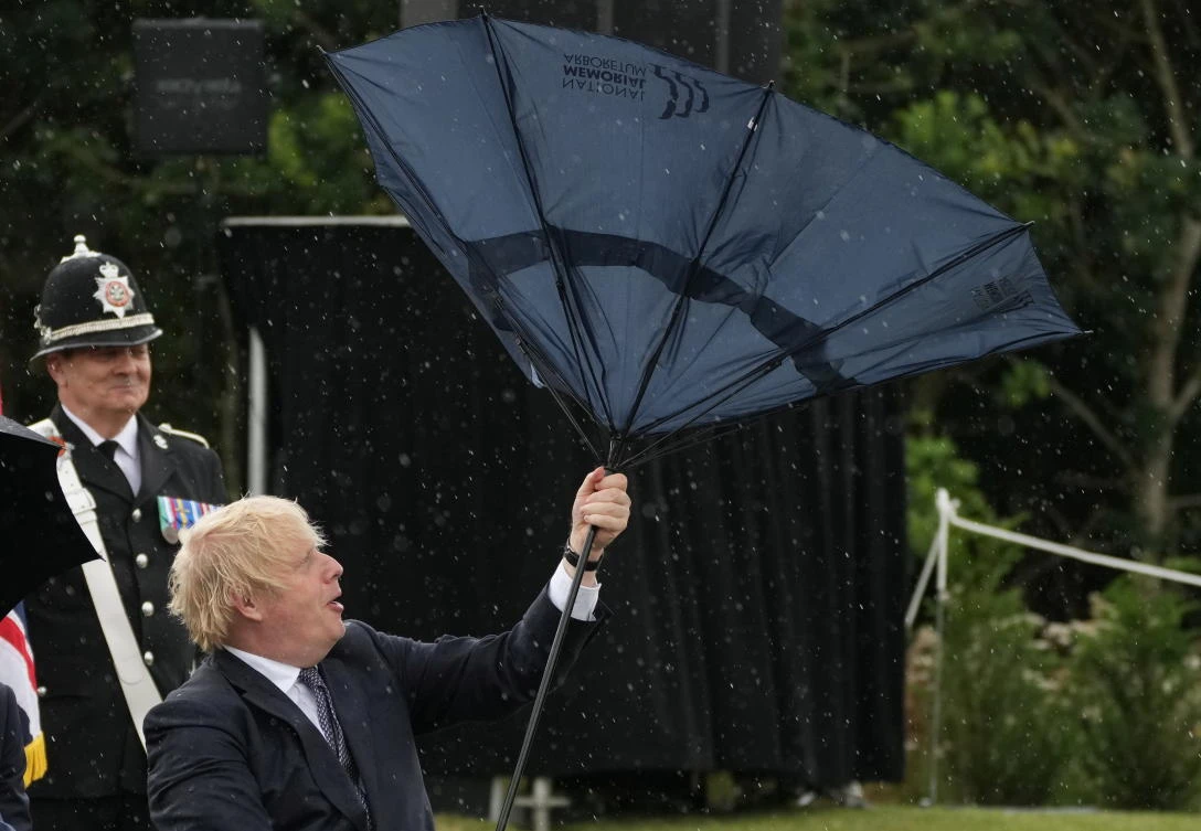 UK PM Johnson’s umbrella mishap amuses Prince Charles