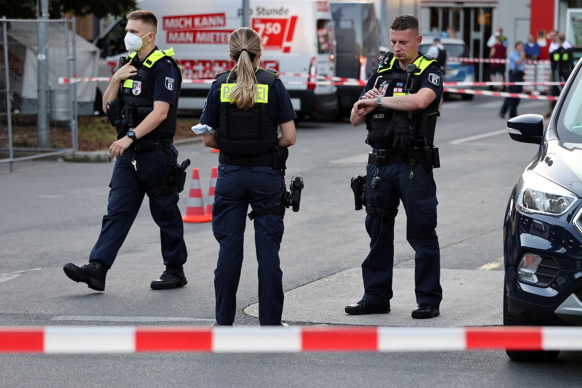 Police officers secure a parking space after a shooting in Berlin, Germany, July 30, 2021. (Reuters)