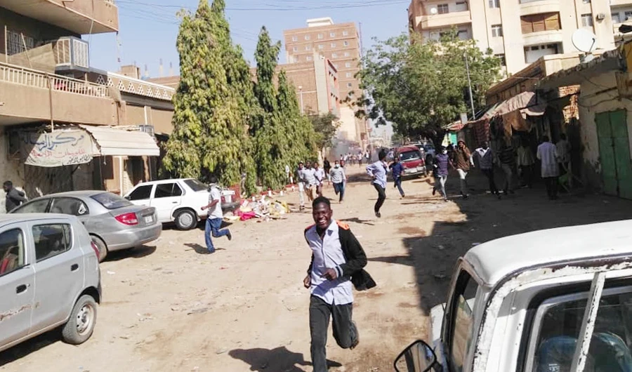 Sudanese protesters run away from tear gas smokes during a demonstration in Khartoum. (AFP file photo)