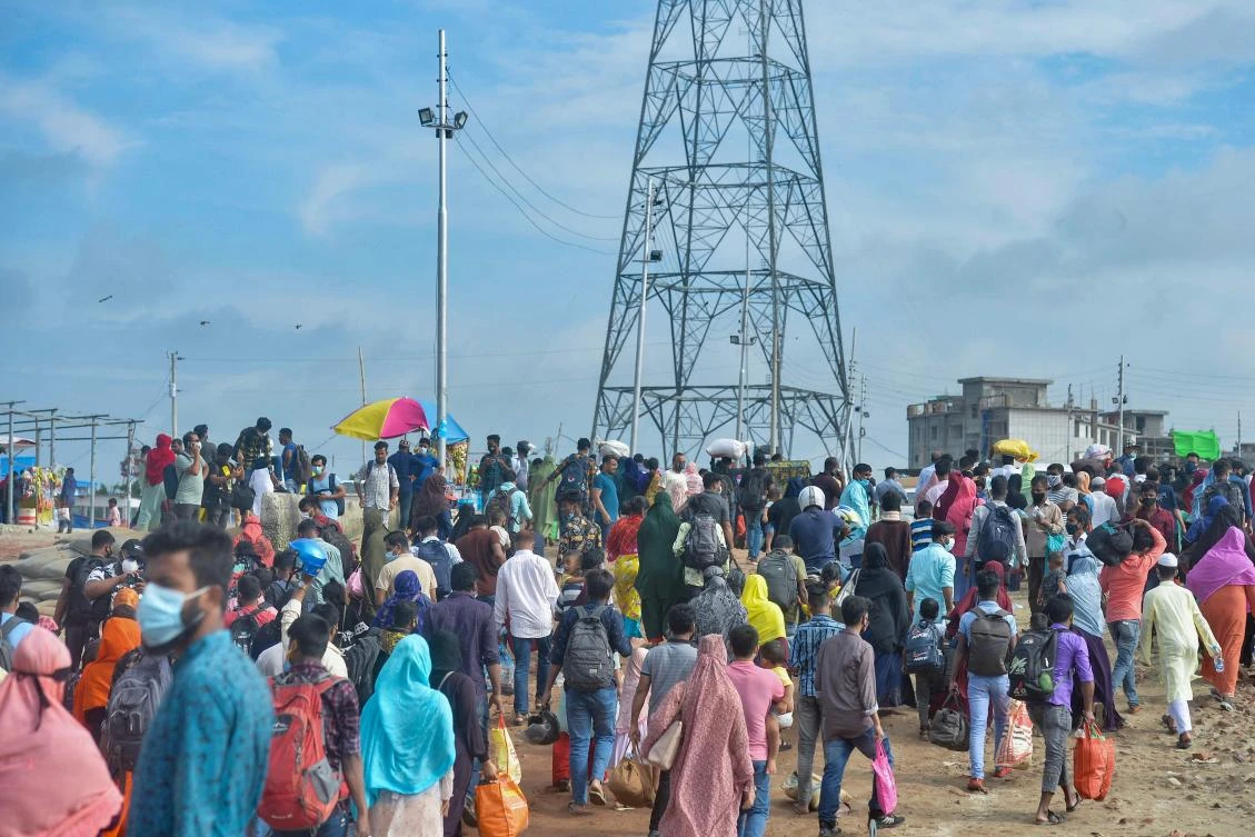 People disembark from a ferry in Sreenagar on July 31, 2021 to resume and return to their work areas post the Bangladesh government relaxed the lockdown norms for all export oriented factories which were earlier imposed to curb the spread of Covid-19 coronavirus. (AFP)