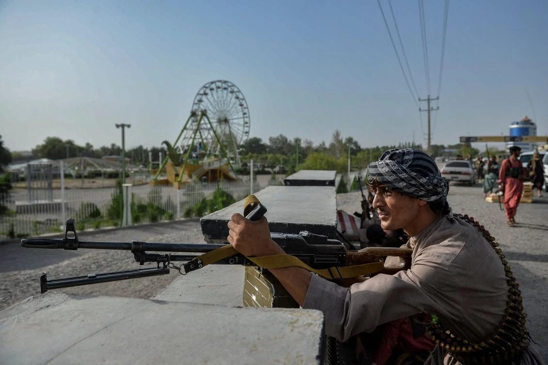 Afghan security personnel and Afghan militia fighting against Taliban stand guard in Enjil district of Herat province on July 30, 2021. (AFP)