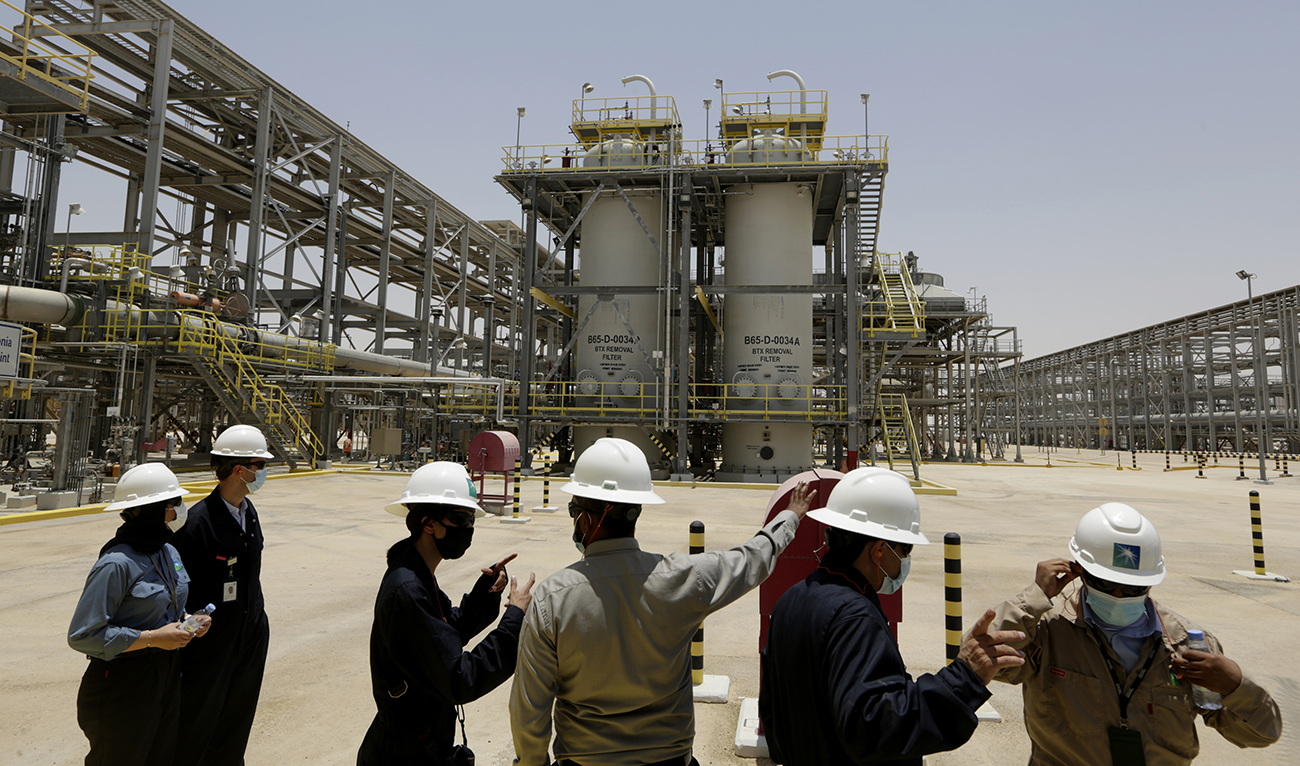 Saudi Aramco engineers and journalists look at the Hawiyah Natural Gas Liquids Recovery Plant. (AP/File)