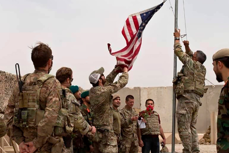 The US flag is lowered at Camp Anthonic in Helmand province, Afghanistan. (AP Photo)