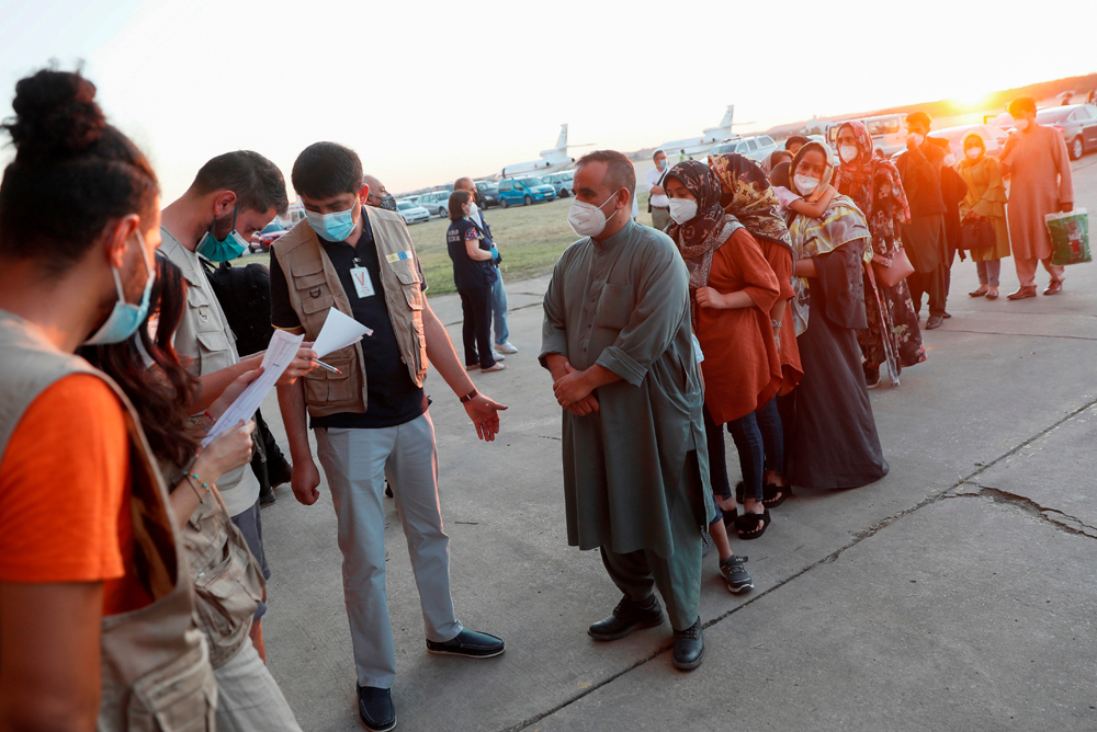 Afghan citizens, who were evacuated from Kabul, arrive at Torrejon Air Base in Torrejon de Ardoz, outside Madrid, Spain, Aug. 20, 2021. (Reuters)