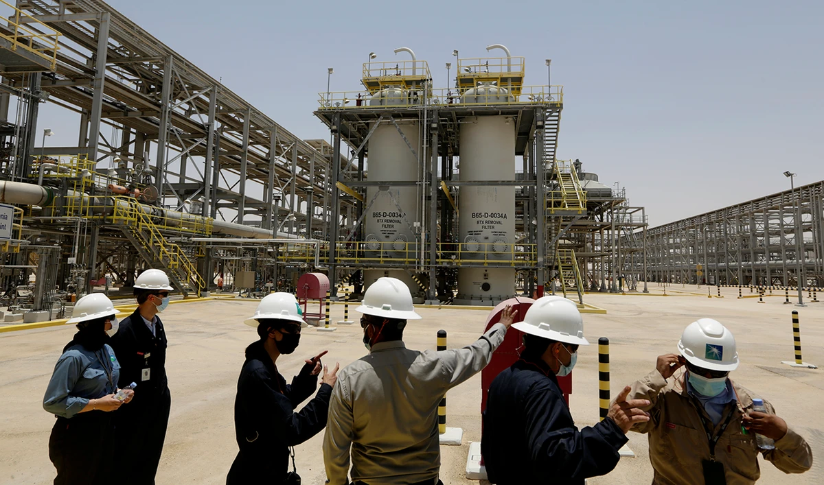 Saudi Aramco engineers and journalists look at the Hawiyah Natural Gas Liquids Recovery Plant. (AP/File)