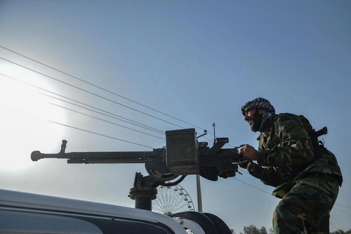Afghan security personnel and Afghan militia fighting against Taliban, stand guard in Enjil district of Herat province on July 30, 2021. on July 30, 2021. (AFP)