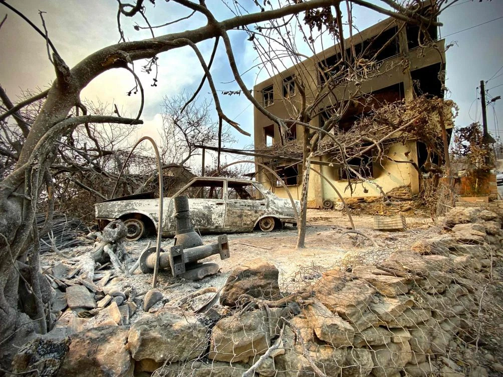 Above, a burnt car in front of a razed house as a massive forest fire which engulfed a Mediterranean resort region on Turkey’s southern coast. (AFP)