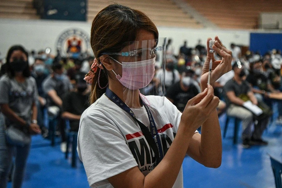 A health worker prepares a dose of the Pfizer jab in Manila. (AFP/File)