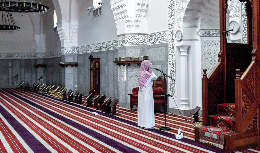 In this file photo taken on April 28, 2020, a muezzin of the Jaffali mosque in Jeddah calls for prayer at the mosque. (AFP)