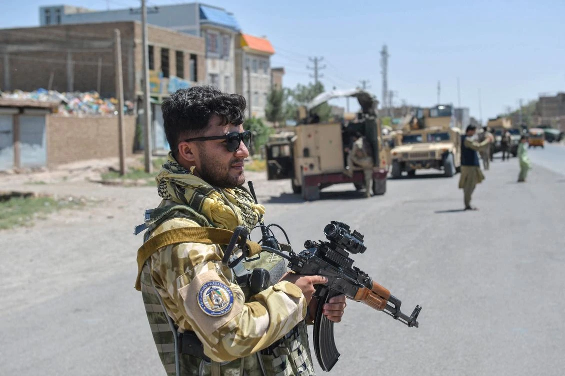 Above, an Afghan National Army commando stands guard along the road in Enjil district of Herat province on Aug. 1, 2021 as skirmishes between Afghan National Army and Taliban continues. (AFP)