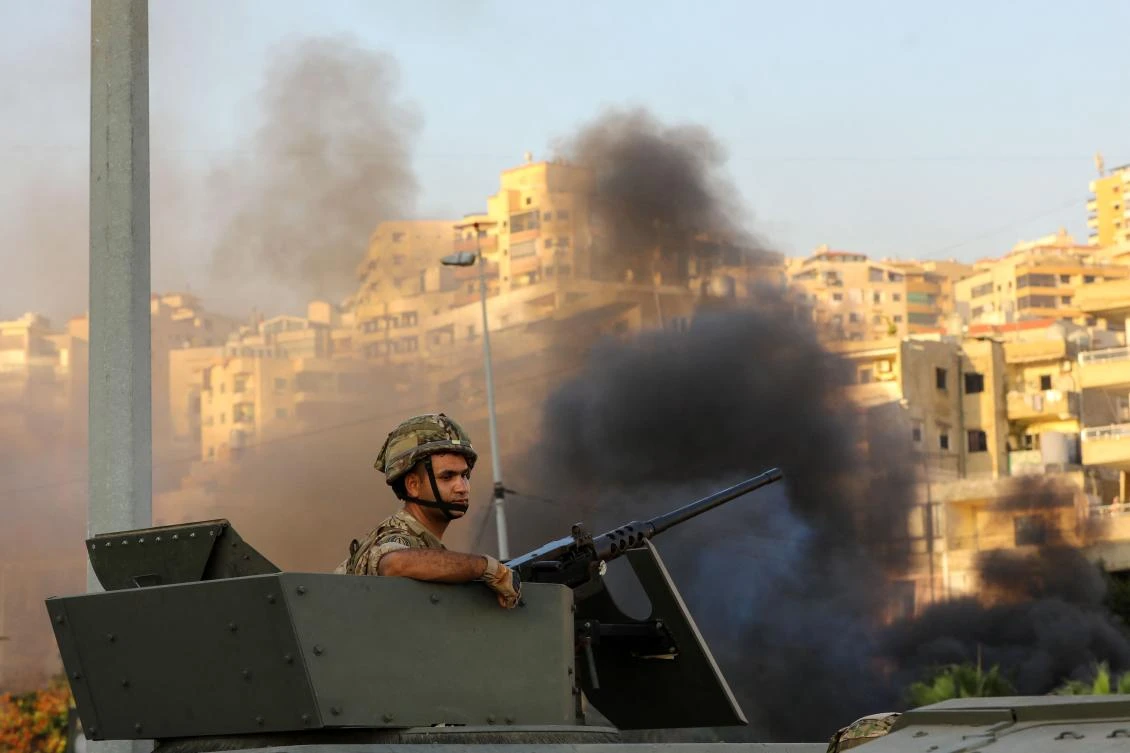 A Lebanese soldier sits in an armored vehicle as the army deploys amid clashes in the Khalde area on August 1 that killed 5 people including 3 Hezbollah members. (AFP)