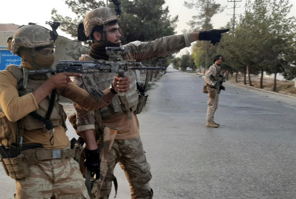 Afghan Special forces patrol a deserted street during fighting with Taliban fighters, in Lashkar Gah, Helmand province on Tuesday. (AP)