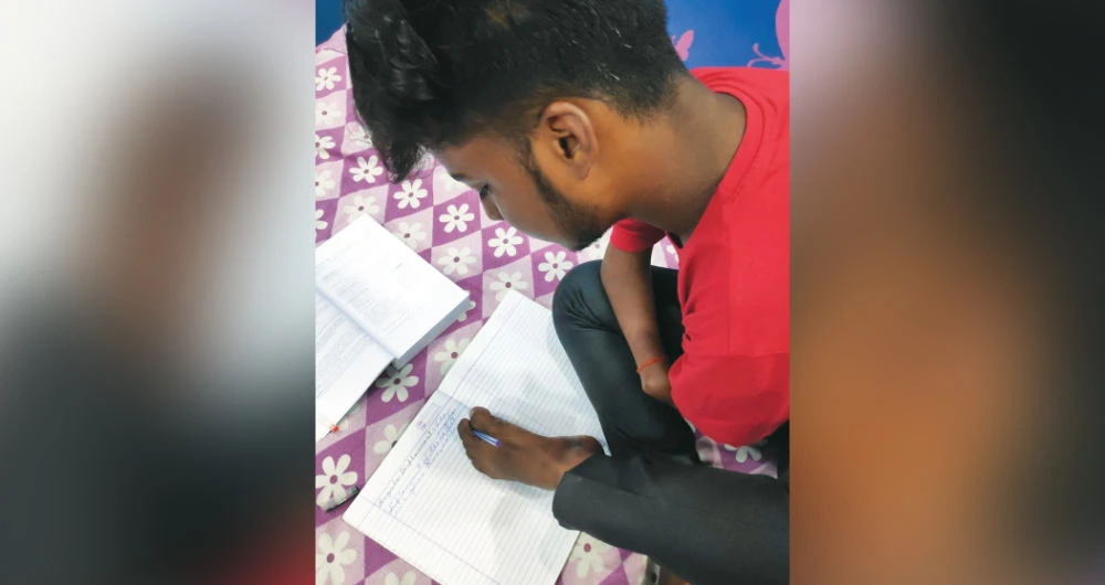 Disabled Indian teen achieves top scores despite writing exams with his feet