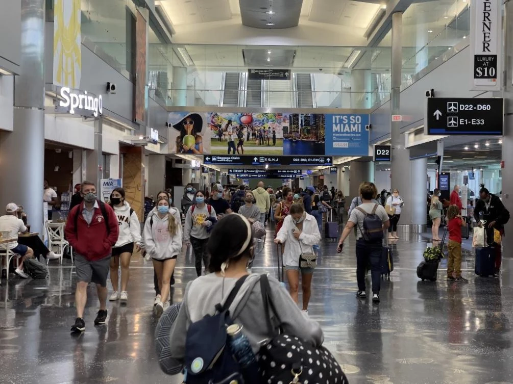 The Biden administration has faced pressure to lift some restrictions from affected allies. Above, passengers and others walk at Miami International Airport on Aug. 1, 2021 in Miami, Florida. (AFP)