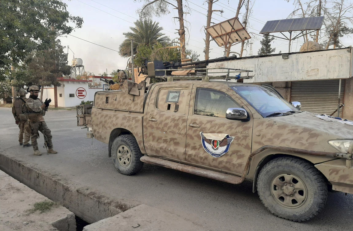 Afghan Special forces patrol a deserted street during fighting with the Taliban, in Lashkar Gah, Helmand province, southern Afghanistan, Tuesday, Aug. 3, 2021. (AP)
