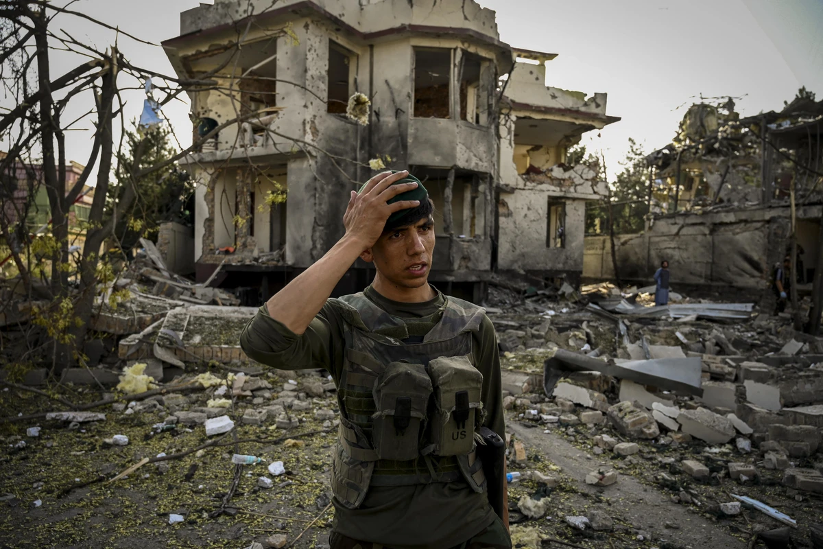 An Afghan security personnel gestures as he stands guard at the site a day after a car bomb explosion in Kabul on August 4, 2021. (AFP)