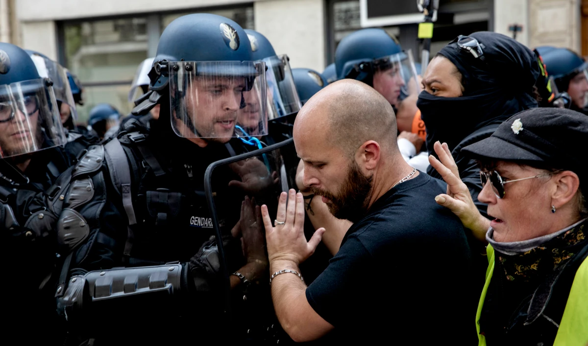 Protesters and police face during a protest against the vaccine and vaccine passports, in Paris, France, Saturday Aug. 7, 2021. (AP)