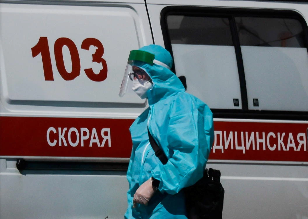 A medical specialist walks by an ambulance outside a hospital for patients infected with COVID-19 in Moscow, Russia. Local health ministry was cited saying Monday 9 patients with coronavirus died due to a lack of oxygen. (Reuters)