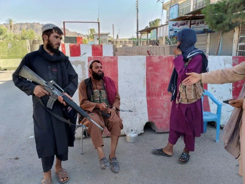Taliban fighters stand guard at a check point in Farah, Afghanistan August 11, 2021. (REUTERS)