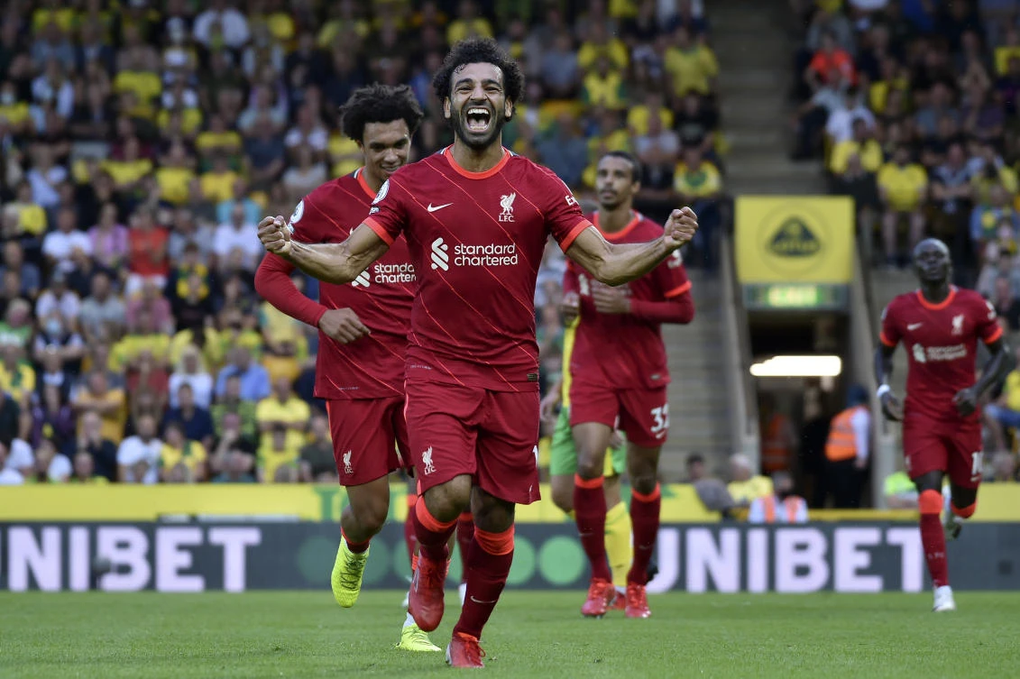 Liverpool's Mohamed Salah celebrates after scoring his side's third goal during the English Premier League match against Norwich City at Carrow Road Stadium in Norwich on Saturday. (AP)