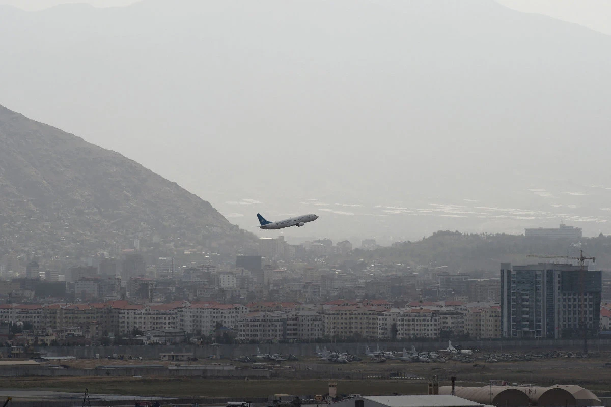 This picture taken on August 14, 2021 shows an Ariana Afghan Airlines aircraft taking off from the airport in Kabul. (Photo by Wakil Kohsar)