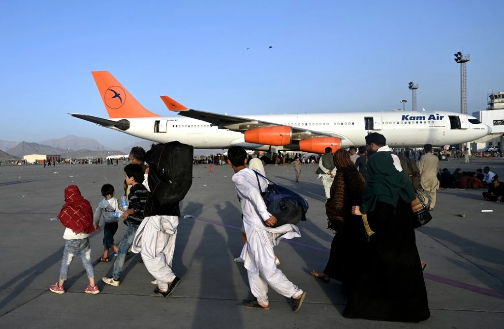 Large throngs of Afghan crowds seeking their way out of the country overwhelmed Kabul airport on Sunday. (AFP)