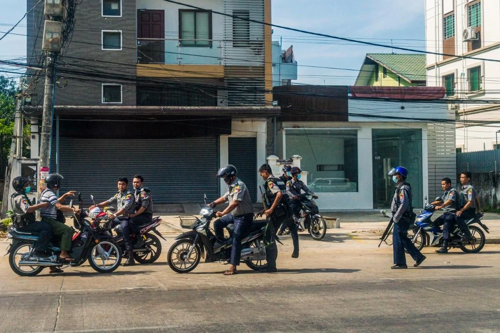 Myanmar’s security forces responded to protests with bloody crackdowns, using live rounds against civilians. Above, police search for protesters taking part in a demonstration on May 15, 2021. (AFP)