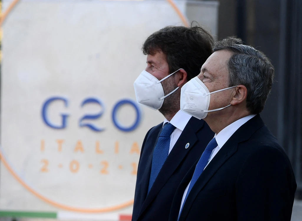 Italian Prime Minister Mario Draghi (R) and culture minister Dario Franceschini arrive at the Colosseum on the first day of the G20 Culture Ministers meeting on July 29, 2021 in Rome. (File/AFP)