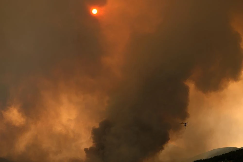 An helicopter operates during a wildfire in Vilia area some 60 kilometers (37 miles) northwest of Athens, Greece, Wednesday, Aug. 18, 2021. (File/AP)