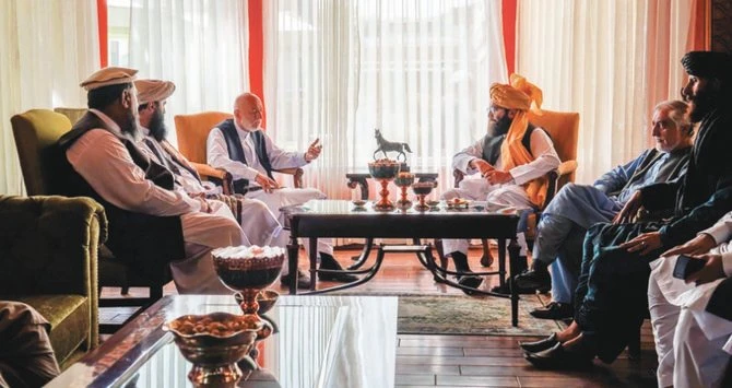 Former Afghan President Hamid Karzai, center left, and senior Haqqani group leader Anas Haqqani, center right, meet in Kabul on August 18, 2021. (AP)