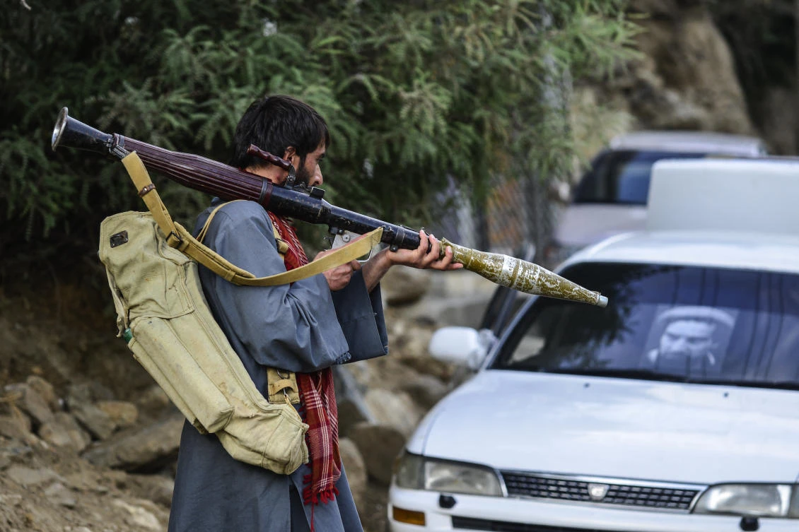 An Afghan armed man supporting the Afghan security forces against the Taliban carries a weapon as he walks along a road in Bazarak, Panjshir province, on August 18, 2021.(File/AFP)