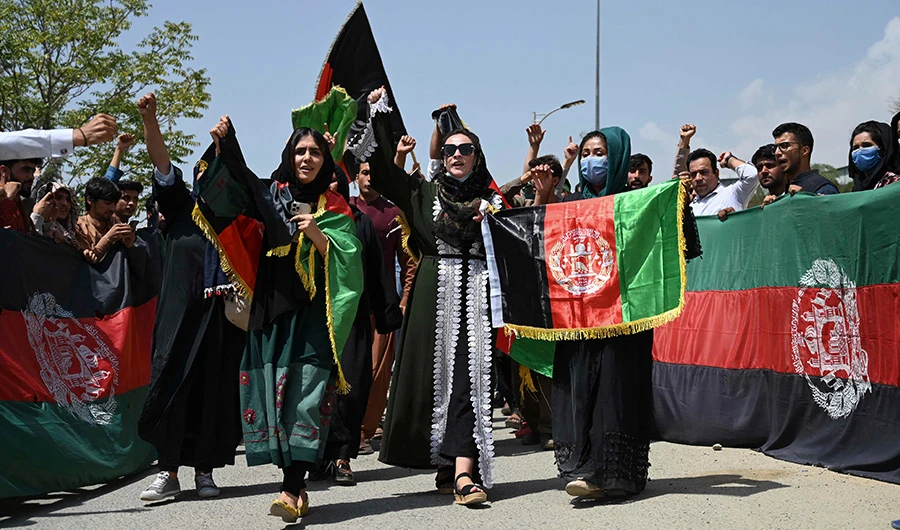 Afghans celebrate the 102th Independence Day of Afghanistan with the national flag in Kabul on August 19, 2021. (AFP)