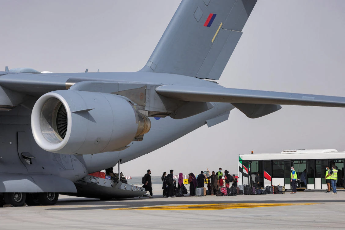 People disembark off a military transport aircraft carrying evacuees from Afghanistan and arriving at Al-Maktoum International Airport in the United Arab Emirates on August 19, 2021. (File/AFP)