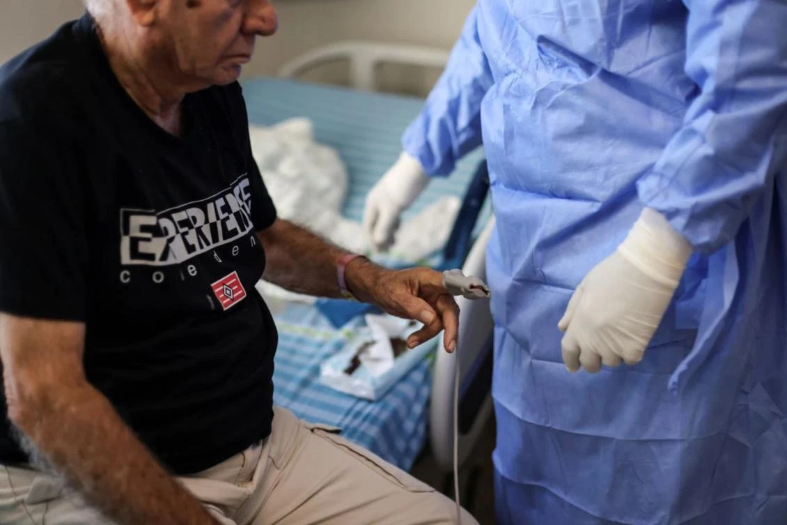 A medical staff member attends to a patient suffering from the coronavirus disease (COVID-19), in a ward at Beilinson hospital in Petah Tikva, Israel. (File/Reuters)