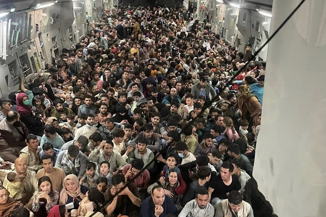 Afghan citizens pack inside a U.S. Air Force C-17 Globemaster III, as they are transported from Hamid Karzai International Airport in Afghanistan, Sunday, Aug. 15. (Air Force via AP)