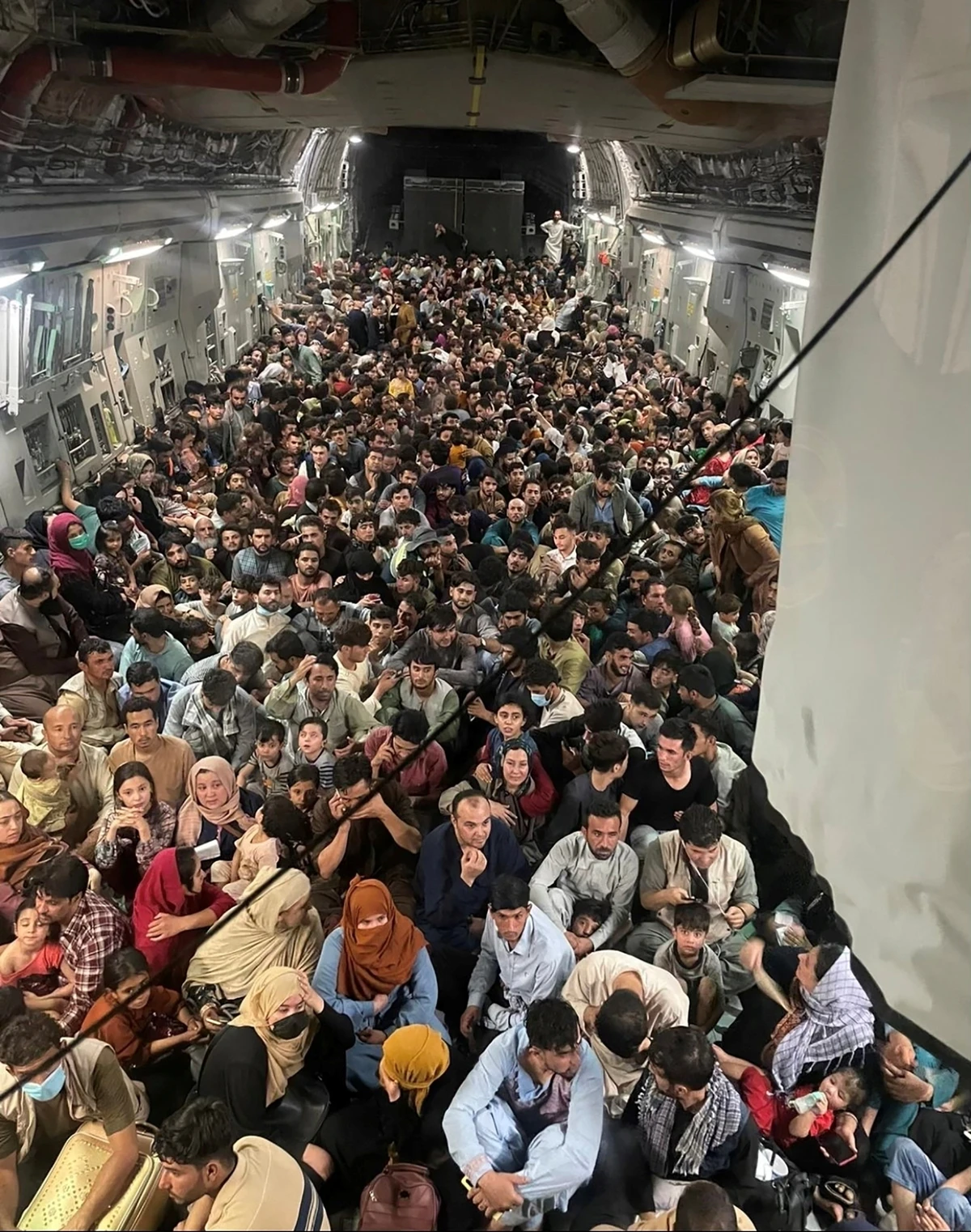 Evacuees crowd the interior of a U.S. Air Force C-17 Globemaster III transport aircraft, carrying some 640 Afghans to Qatar from Kabul, Afghanistan. (Reuters)