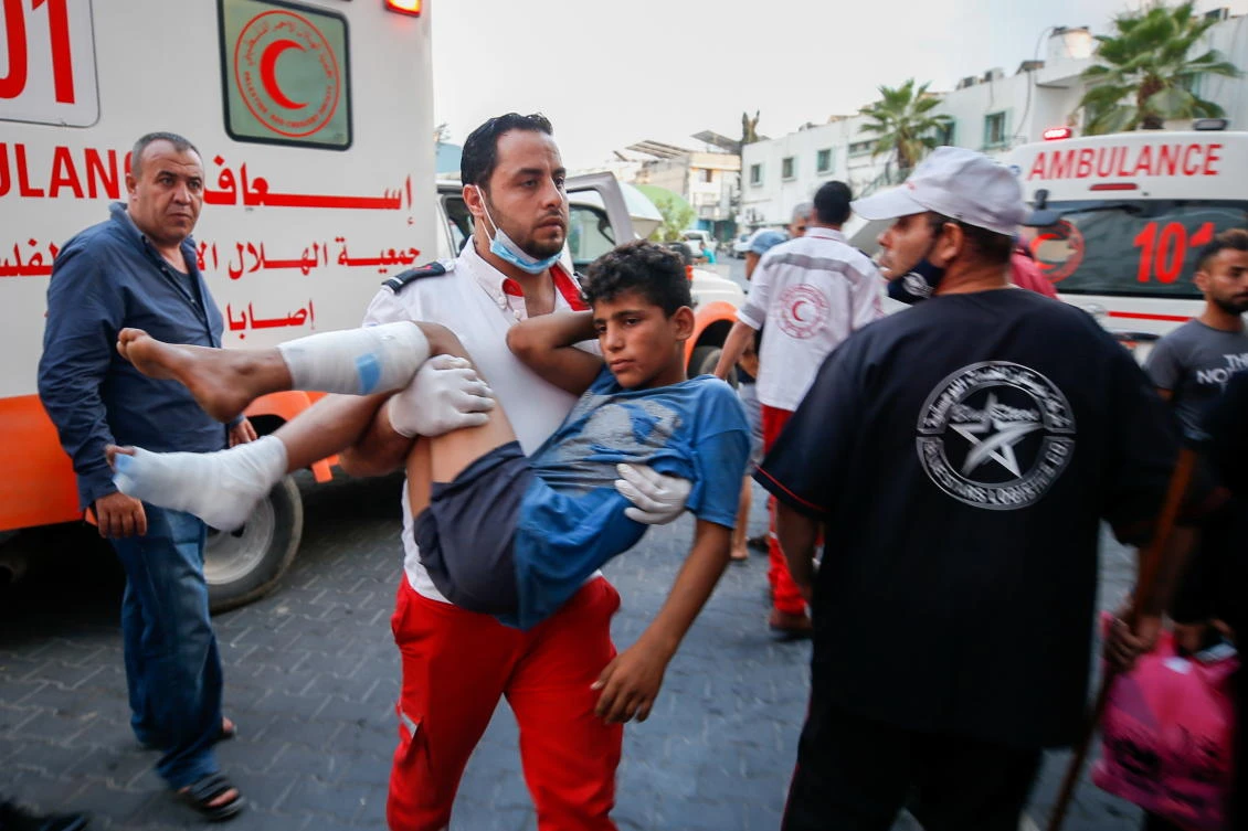 A wounded Palestinian is carried after taking part in a protest at Israel-Gaza border east of Gaza City, August 21, 2021. (Reuters)