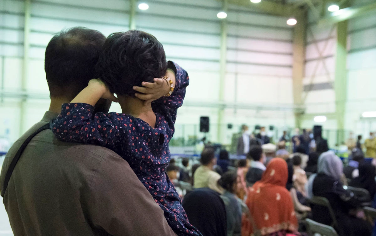 This handout photo taken on August 21, 2021 shows People who fled Afghanistan waiting for another flight at the air base of Al Dhafra, near Abu Dhabi as part of the operation "Apagan". (AFP)