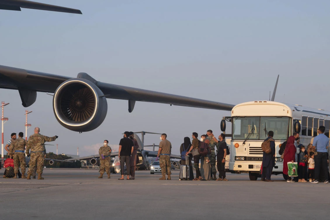A group of Afghan evacuees exit a C-17 Globemaster III aircraft at Ramstein Air Base, Germany on Friday, Aug. 20, 2021, after being evacuated from Kabul, Afghanistan. (US Air Force via AP)
