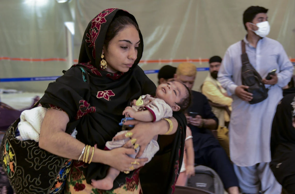 People evacuated from Kabul arrive at Hindon Air force base near New Delhi, India. Sunday, Aug. 22, 2021. (AP Photo)