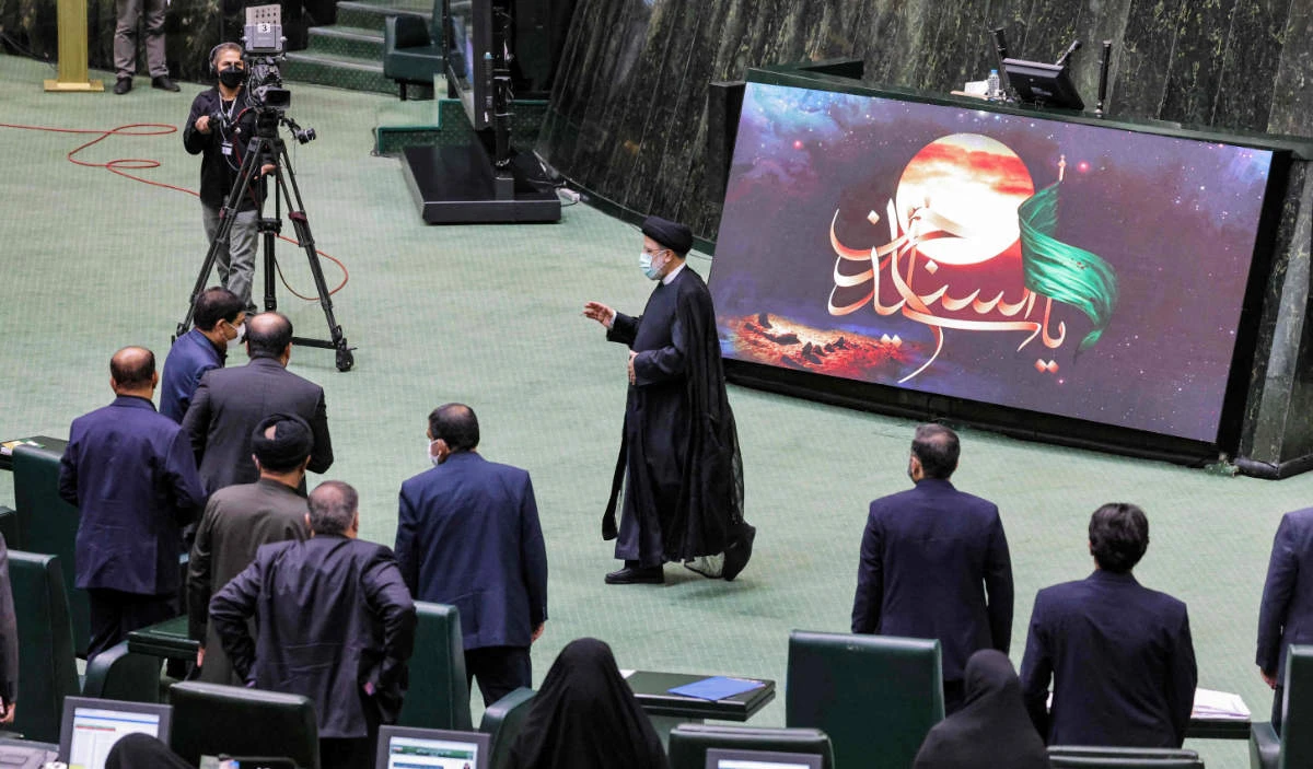 Iran's President Ebrahim Raisi walks during a parliament session reviewing his cabinet selection in the capital Tehran on August 21, 2021. (AFP)