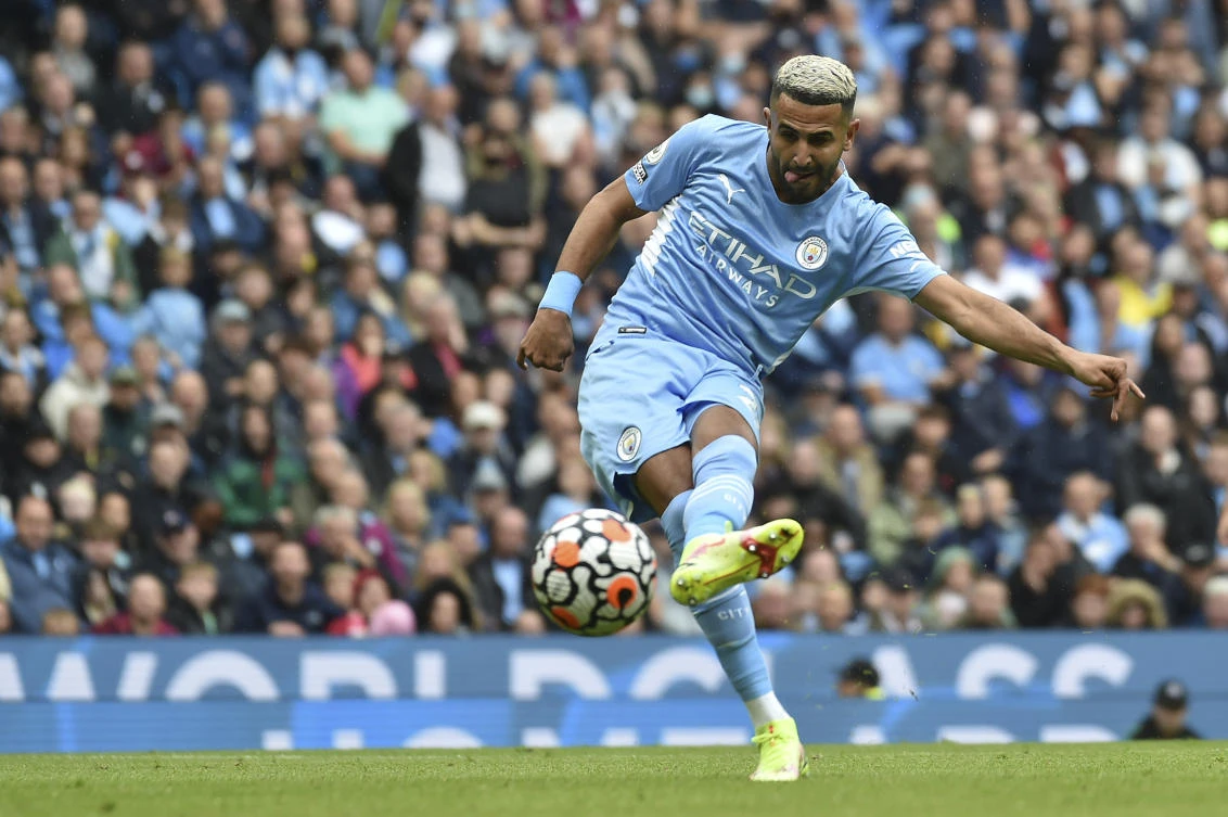 Manchester City’s Riyad Mahrez scores his side’s 5th goal during English Premier League match against Norwich City at Etihad stadium on Saturday. (AP)