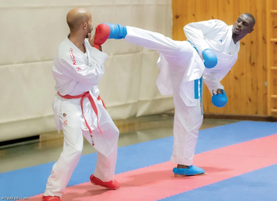 Tarek Hamdi, right, with Fahad Al-Khathami at the training camp on Monday night. (Arriyadiyah)